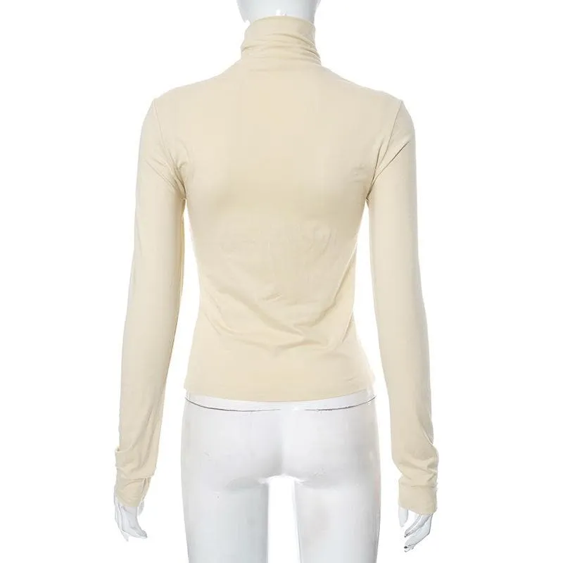 Metal applique turtle neck long sleeve solid top